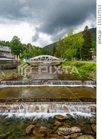 Famous white bridge over Elbe river at Spindleruv Mlyn city, Czech Republic. Famous tourist destination. 131127513