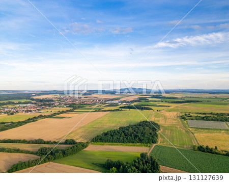 A stunning drone view of Hrusovany u Brna, showcasing the charming town, surrounding vineyards, and a distant, scenic view of the Palava Hills. 131127639