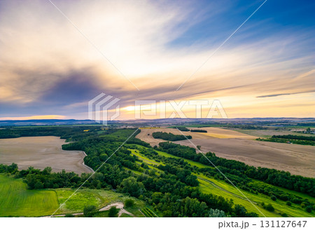 A stunning drone view of Hrusovany u Brna, showcasing the charming town, surrounding vineyards, and a distant, scenic view of the Palava Hills. A stunning drone view of Hrusovany u Brna, showcasing the charming town, surrounding vineyards, and a distant, scenic view of the Palava Hills. 131127647