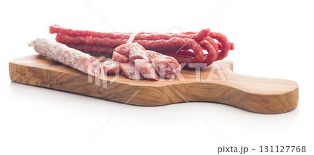 Sliced fuet sausage with mold isolated on white background. Sliced fuet sausage with mold isolated on white background. 131127768