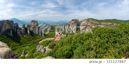 Monastery Meteora Greece. Stunning summer panoramic landscape. View at mountains and green forest against epic blue sky with clouds. UNESCO heritage list object. Monastery Meteora Greece. Stunning summer panoramic landscape. View at mountains and green forest against epic blue sky with clouds. UNESCO heritage list object. 131127867