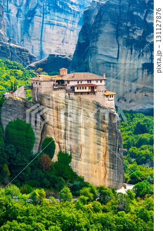 Monastery Meteora Greece. Stunning summer panoramic landscape. View at mountains and green forest against epic blue sky with clouds. UNESCO heritage list object. 131127876