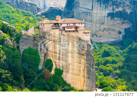 Monastery Meteora Greece. Stunning summer panoramic landscape. View at mountains and green forest against epic blue sky with clouds. UNESCO heritage list object. 131127877