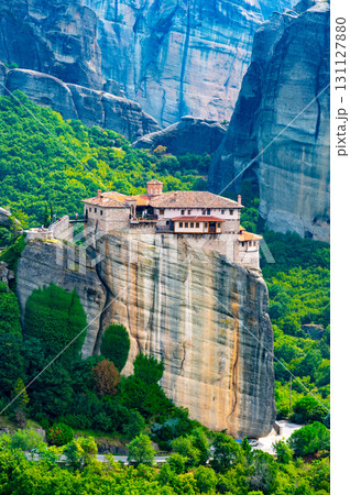 Monastery Meteora Greece. Stunning summer panoramic landscape. View at mountains and green forest against epic blue sky with clouds. UNESCO heritage list object. 131127880