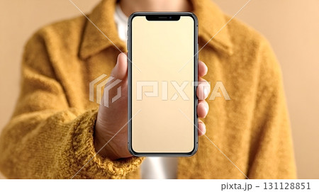 Woman holding smartphone with blank screen showing mobile app design 131128851