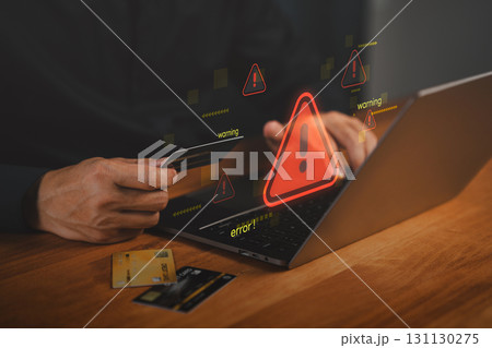 Hacker warning alert during online credit card payment on laptop. Concept of cybersecurity breach, financial fraud, phishing scam, identity theft, digital transaction risks in e-commerce environments. 131130275