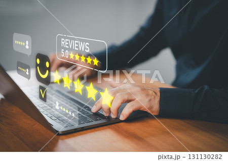 Customer giving 5 star review online using laptop, showing satisfaction and positive feedback, ideal for business reputation, testimonial, customer experience, marketing, and e-commerce concept. 131130282