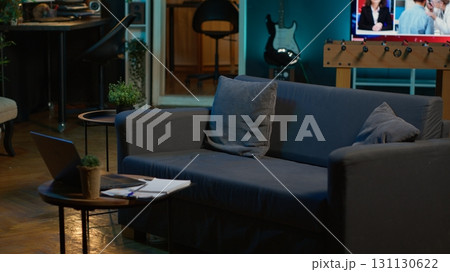Empty contemporary studio apartment with modern decorations and equipment for a young adult, minimalist space decorated with led neon lights. Cozy urban loft with a home theatre setup. Empty contemporary studio apartment with modern decorations and equipment for a young adult, minimalist space decorated with led neon lights. Cozy urban loft with a home theatre setup. 131130622