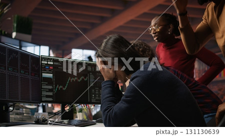 Startup team concerned by company stock valuation dropping, signaling future funding challenges. Venture management distraught by financial decline leading to budget cuts and layoffs, camera A 131130639