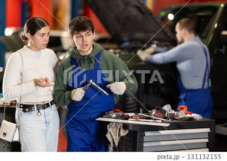 female client listens to recommendations for car repair female client listens to recommendations for car repair 131132155