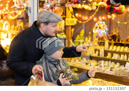 Father and son choose figures for the nativity scene 131132307