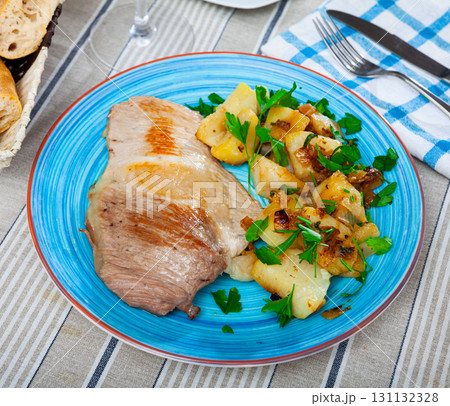 Steaks of pork loin with homestyle boiled potatoes Steaks of pork loin with homestyle boiled potatoes 131132328