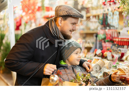 Man and son choosing Christmas decorations 131132337