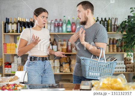 Man and woman quarrel in supermarket - they shout at each other 131132357