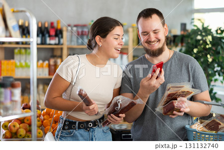 couple scans the QR code of meat products on their phone couple scans the QR code of meat products on their phone 131132740