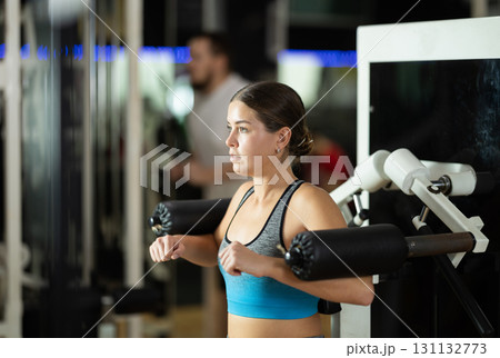 Woman training her hands in the machine Woman training her hands in the machine 131132773