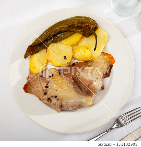 Spanish Secreto de cerdo - roasted pork served with potatoes, stewed pepper Spanish Secreto de cerdo - roasted pork served with potatoes, stewed pepper 131132905