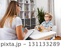 Child Engaged in Educational Activity with Teacher at Home 131133289