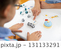 Child Learning with Alphabet Blocks and Flashcards at Table 131133291