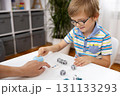 Child Engaged in Educational Game with Blocks and Bell 131133293