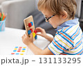 Child Engaged in Educational Toy Activity at Home 131133295