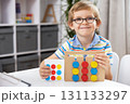Smiling Child Engaged in Educational Toy Activity at Home 131133297