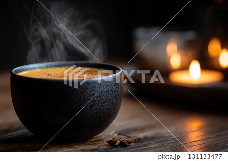 Moody Pumpkin Latte in Black Cup with Cinnamon Smoke and Candlelight 131133477