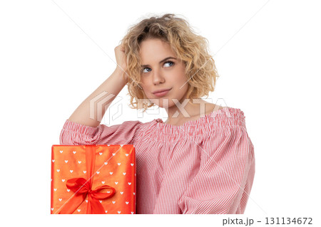 Woman curiously examines a gift box, isolated on white, PNG Woman curiously examines a gift box, isolated on white, PNG 131134672