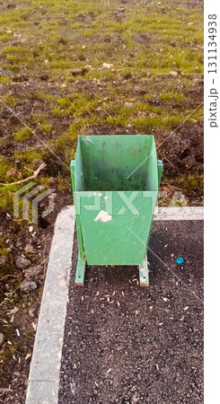 Urban trash receptacle documentary style in muted green tones symbolizing sanitation and litter control Urban trash receptacle documentary style in muted green tones symbolizing sanitation and litter control 131134938