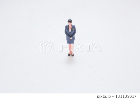Small Businesswoman Figurine In Navy Suit Standing Small Businesswoman Figurine In Navy Suit Standing 131135017