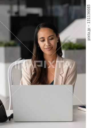 Beautiful young Maori company employee woman working at computer Beautiful young Maori company employee woman working at computer 131136085