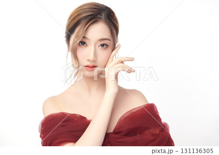 A beautiful young Asian woman with clean, fresh skin against a white background. Skincare, facial treatment, cosmetology, beauty, and spa. An elegant portrait of an Asian woman. A beautiful young Asian woman with clean, fresh skin against a white background. Skincare, facial treatment, cosmetology, beauty, and spa. An elegant portrait of an Asian woman. 131136305