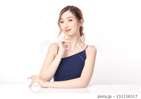 A beautiful young Asian woman with clean, fresh skin against a white background. Skincare, facial treatment, cosmetology, beauty, and spa. An elegant portrait of an Asian woman. 131136317