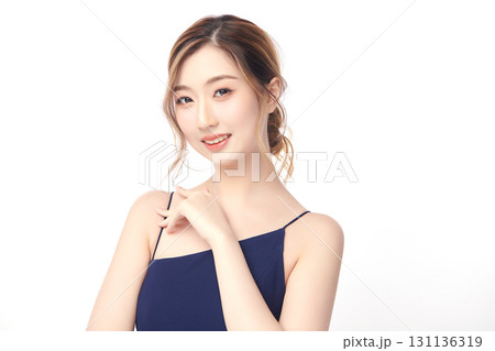 A beautiful young Asian woman with clean, fresh skin against a white background. Skincare, facial treatment, cosmetology, beauty, and spa. An elegant portrait of an Asian woman. A beautiful young Asian woman with clean, fresh skin against a white background. Skincare, facial treatment, cosmetology, beauty, and spa. An elegant portrait of an Asian woman. 131136319