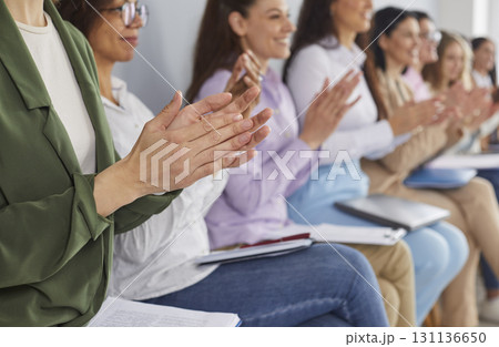 Happy audience clapping hands after a speech at a public business conference or seminar 131136650