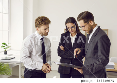 Company employees discussing a work project on a meeting in the office. 131136673