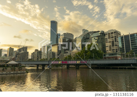 Melbourne, Australia - December 28,2023 : Evan Walker or Southbank Pedestrian bridge with people walking in Melbourne, Australia on December 28,2023. Melbourne, Australia - December 28,2023 : Evan Walker or Southbank Pedestrian bridge with people walking in Melbourne, Australia on December 28,2023. 131138116
