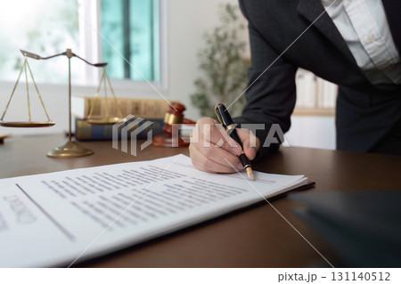 Lawyer signing legal documents in office setting Lawyer signing legal documents in office setting 131140512