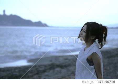 湘南海岸・夕暮れの海辺の一人の女性 湘南海岸・夕暮れの海辺の一人の女性 131140716