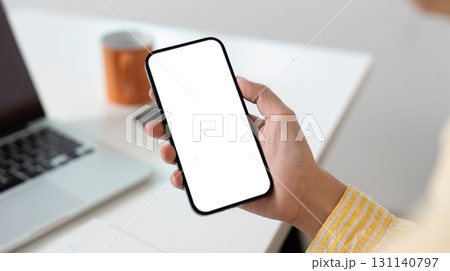 Mobile Technology. Person holding smartphone with blank display for digital marketing purposes. Mobile Technology. Person holding smartphone with blank display for digital marketing purposes. 131140797