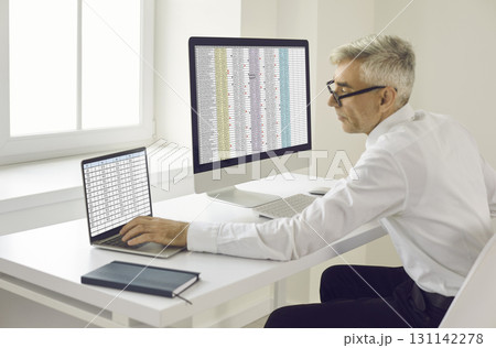 Senior businessman calculating electronic invoice. Senior businessman calculating electronic invoice. 131142278