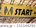 Start line banner with checkered flags signaling the beginning of a racing event 131144292