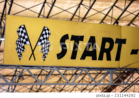 Start line banner with checkered flags signaling the beginning of a racing event 131144292
