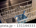 Clean glassware arranged in a dishwasher basket ready for drying and storage in a modern kitchen 131144333
