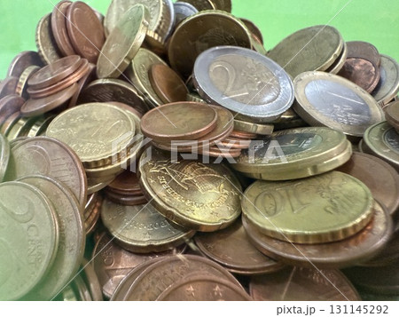 Close-up of Euro coins in container. Glass piggy bank for money. Saving money to buy necessary things. Close-up of Euro coins in container. Glass piggy bank for money. Saving money to buy necessary things. 131145292