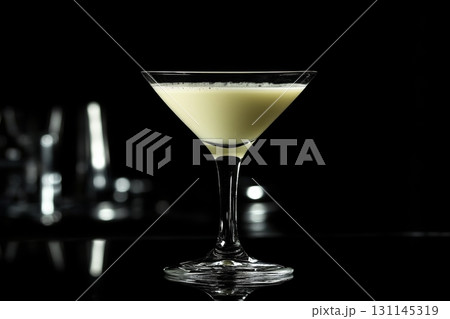 Cocktail presented in a sleek crystal glass, highlighting its creamy texture and inviting color against a dark, minimalist background Cocktail presented in a sleek crystal glass, highlighting its creamy texture and inviting color against a dark, minimalist background 131145319
