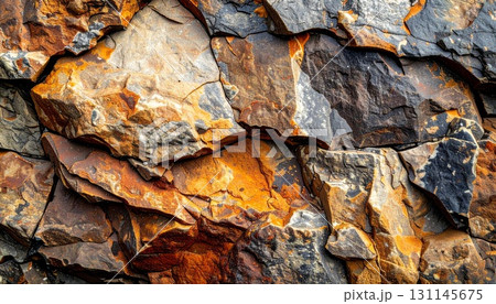 Detailed Close Up of a Weathered Orange and Gray Rock Texture with Rough Surface 131145675