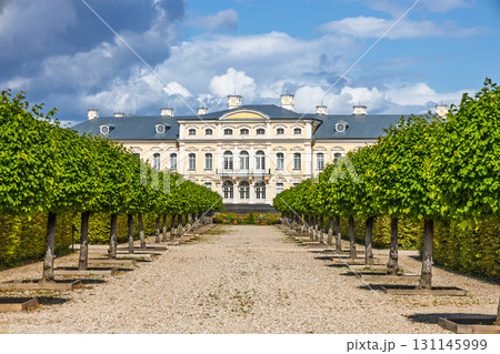 Rundale Palace - Baroque architecture with tree lined alley in the formal gardens, Latvia Rundale Palace - Baroque architecture with tree lined alley in the formal gardens, Latvia 131145999