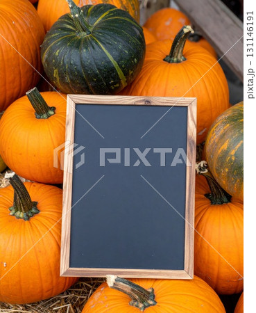 Assortment of Pumpkins and Gourd with Dark Blank Chalkboard in a Rustic Autumn Arrangement 131146191