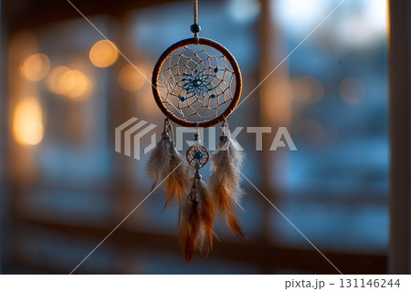 Dreamcatcher Glow. A dreamcatcher with feathers hangs in soft, warm light 131146244